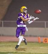 Lemoore's Victor Yanez (No. 15), a wide receiver, cradles a touchdown pass during Friday night's 42-20 victory over Golden West High School. 